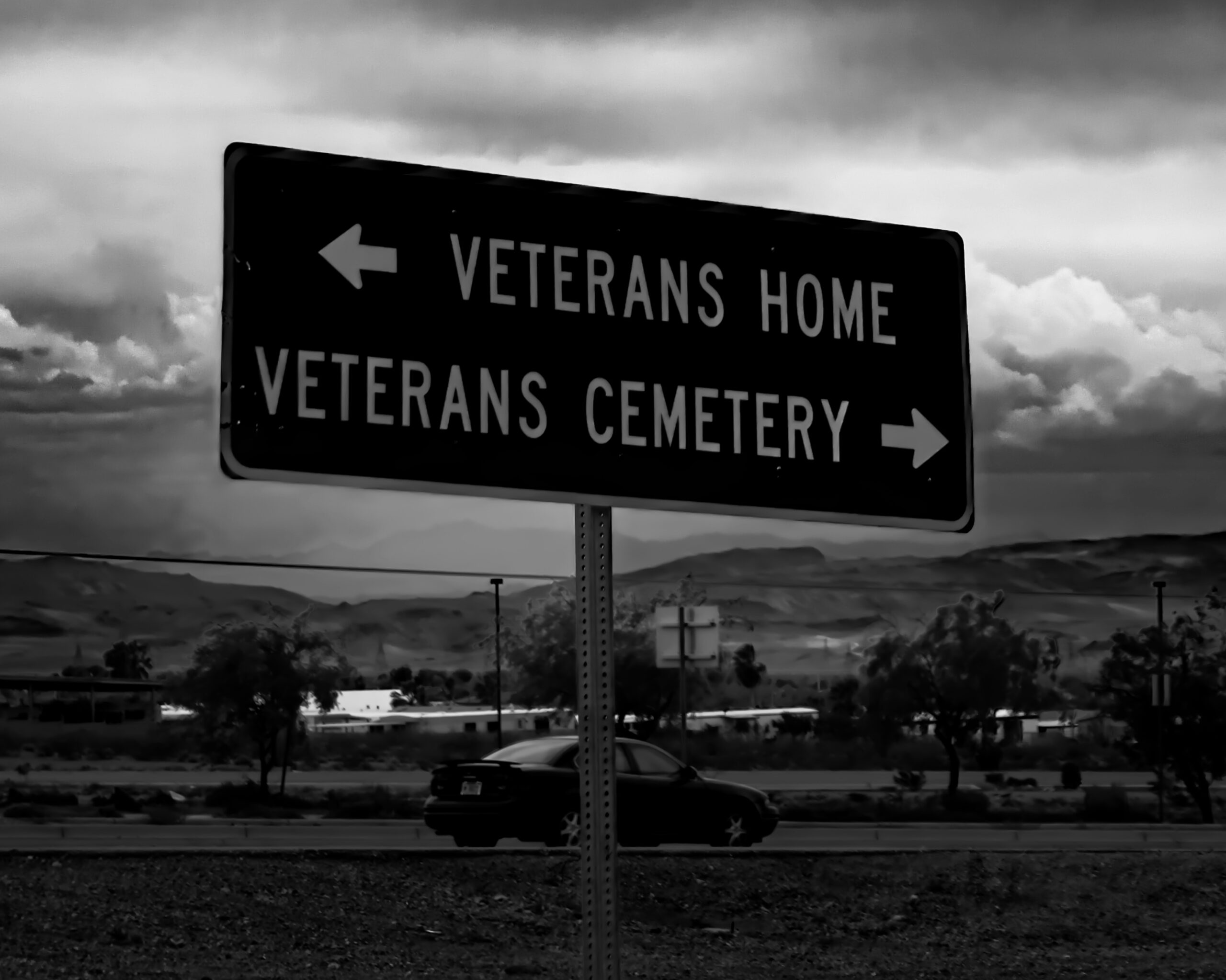 a black and white photo of a street sign